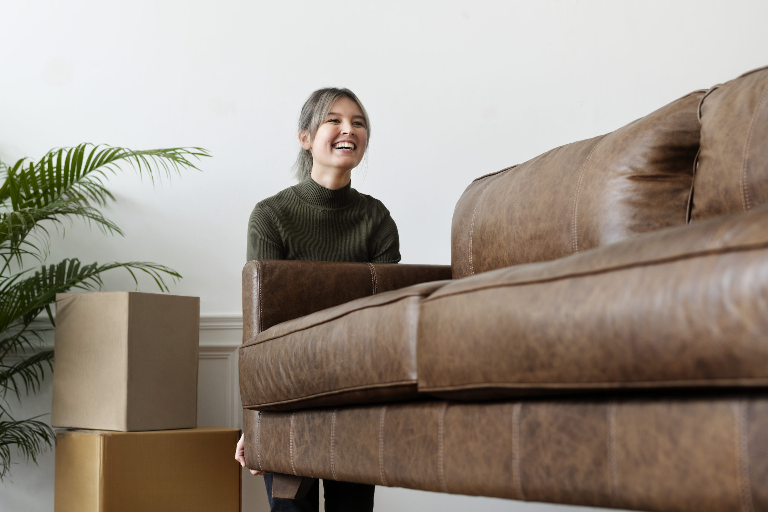 Woman moving the sofa