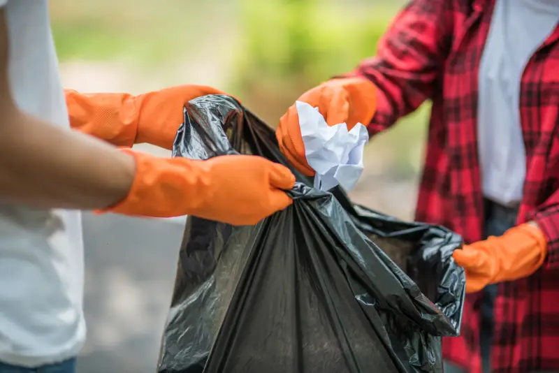 men-women-help-each-other-collect-garbage (1)